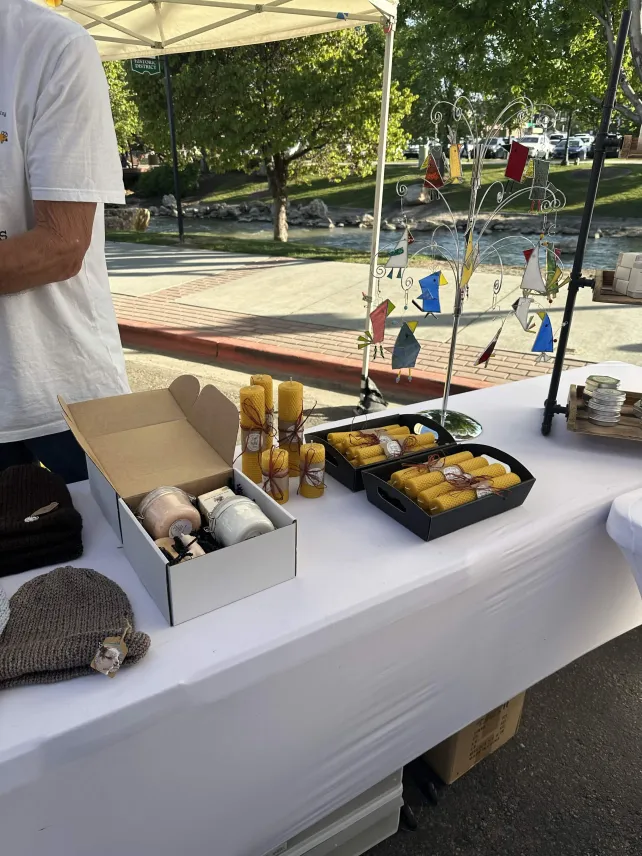 Handmade soaps, beeswax candles, and alpaca beanies at our market table